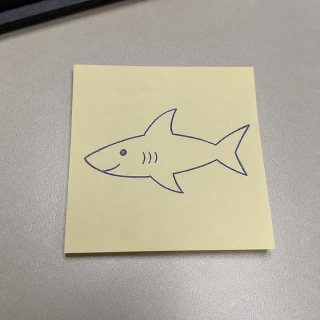 Charming ink and watercolor painting, clean lines, vibrant but soft color palette, storybook style. A close-up photo of a small sticky note placed on a plain office desk, the sticky note is pale yellow, with a small hand-drawn shark sketch on it — simple lines, clearly drawn quickly with a ballpoint pen, with a small smile on the shark's face. No other readable text
Chat attachment instruction: Generate exactly one in-world chat attachment, not a collage, split-screen, comic panel, flashback, or explanatory scene. If the prompt is a screenshot, phone screen, document, note, card, map, receipt, label, object photo, or photo someone took, frame that artifact directly. A name appearing in visible text or in 'photo taken by X' is not an instruction to draw that person. Do not show recurring story participants as visible people unless the prompt itself explicitly says they are visible. Keep unrequested people, faces, and bodies out of the image.