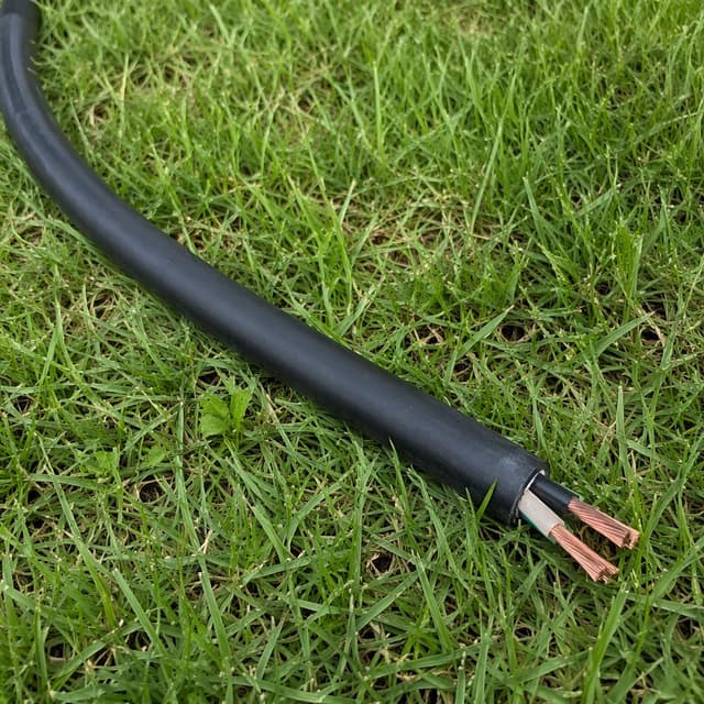 a thick black electrical cable lying on green grass
Chat attachment instruction: Generate exactly one in-world chat attachment, not a collage, split-screen, comic panel, flashback, or explanatory scene. If the prompt is a screenshot, phone screen, document, note, card, map, receipt, label, object photo, or photo someone took, frame that artifact directly. A name appearing in visible text or in 'photo taken by X' is not an instruction to draw that person. Do not show recurring story participants as visible people unless the prompt itself explicitly says they are visible. Keep unrequested people, faces, and bodies out of the image.