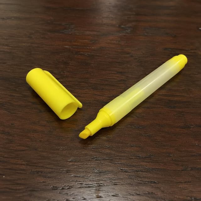 A yellow highlighter marker, uncapped, resting on a plain dark wooden kitchen table, nearly run dry, its cap placed beside it
Chat attachment instruction: Generate exactly one in-world chat attachment, not a collage, split-screen, comic panel, flashback, or explanatory scene. If the prompt is a screenshot, phone screen, document, note, card, map, receipt, label, object photo, or photo someone took, frame that artifact directly. A name appearing in visible text or in 'photo taken by X' is not an instruction to draw that person. Do not show recurring story participants as visible people unless the prompt itself explicitly says they are visible. Keep unrequested people, faces, and bodies out of the image.