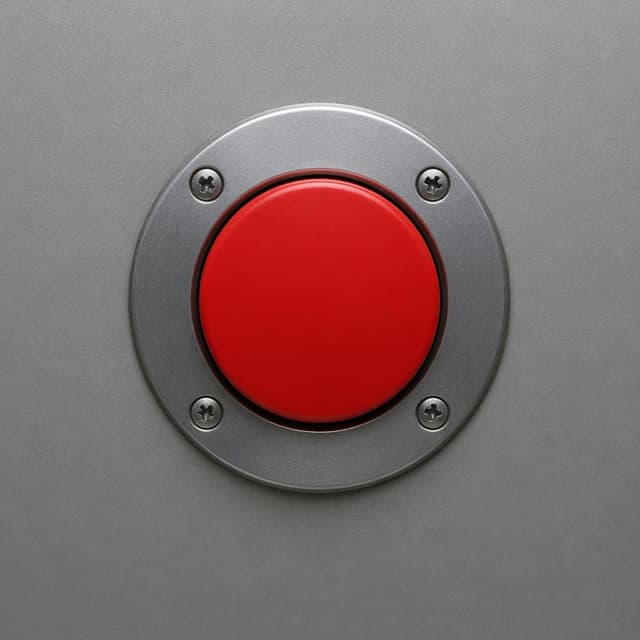 A round red emergency button mounted flush on a plain gray metal panel, close-up, simple background
Chat attachment instruction: Generate exactly one in-world chat attachment, not a collage, split-screen, comic panel, flashback, or explanatory scene. If the prompt is a screenshot, phone screen, document, note, card, map, receipt, label, object photo, or photo someone took, frame that artifact directly. A name appearing in visible text or in 'photo taken by X' is not an instruction to draw that person. Do not show recurring story participants as visible people unless the prompt itself explicitly says they are visible. Keep unrequested people, faces, and bodies out of the image.