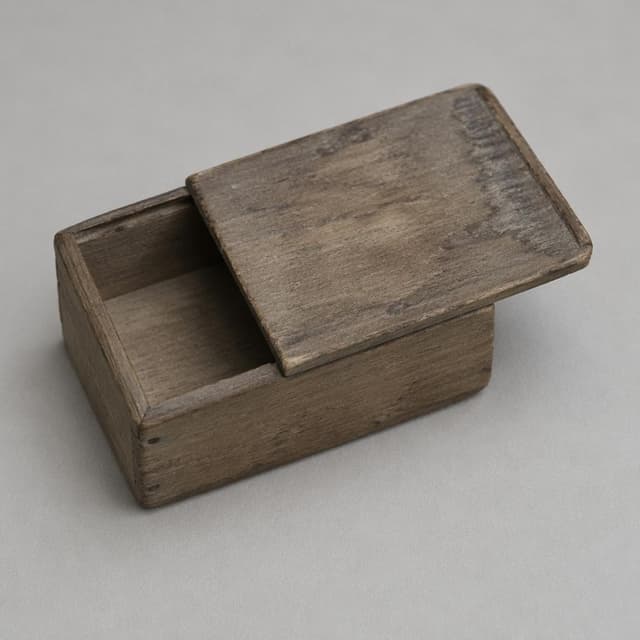 A small, old paulownia wood box with a worn sliding lid, resting on a plain, neutral surface
Chat attachment instruction: Generate exactly one in-world chat attachment, not a collage, split-screen, comic panel, flashback, or explanatory scene. If the prompt is a screenshot, phone screen, document, note, card, map, receipt, label, object photo, or photo someone took, frame that artifact directly. A name appearing in visible text or in 'photo taken by X' is not an instruction to draw that person. Do not show recurring story participants as visible people unless the prompt itself explicitly says they are visible. Keep unrequested people, faces, and bodies out of the image. Do not add readable text unless the prompt explicitly asks for visible text.