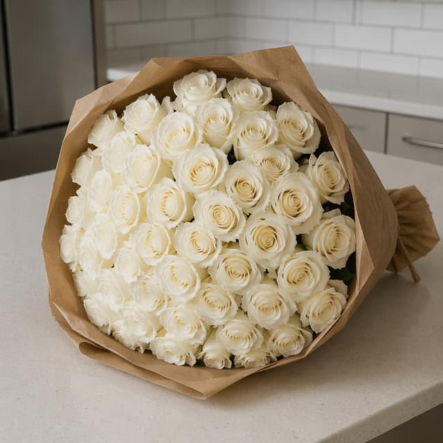 A large bouquet of white roses wrapped in kraft paper on a plain kitchen counter
Chat attachment instruction: Generate exactly one in-world chat attachment, not a collage, split-screen, comic panel, flashback, or explanatory scene. If the prompt is a screenshot, phone screen, document, note, card, map, receipt, label, object photo, or photo someone took, frame that artifact directly. A name appearing in visible text or in 'photo taken by X' is not an instruction to draw that person. Do not show recurring story participants as visible people unless the prompt itself explicitly says they are visible. Keep unrequested people, faces, and bodies out of the image.