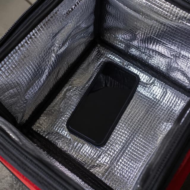 A close-up of a black smartphone lying inside a thermal delivery bag
Chat attachment instruction: Generate exactly one in-world chat attachment, not a collage, split-screen, comic panel, flashback, or explanatory scene. If the prompt is a screenshot, phone screen, document, note, card, map, receipt, label, object photo, or photo someone took, frame that artifact directly. A name appearing in visible text or in 'photo taken by X' is not an instruction to draw that person. Do not show recurring story participants as visible people unless the prompt itself explicitly says they are visible. Keep unrequested people, faces, and bodies out of the image.
