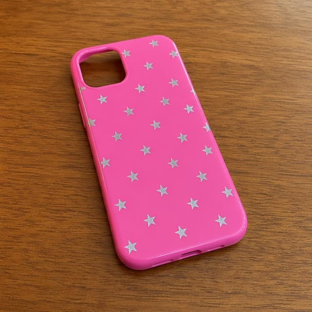 A bright pink phone case decorated with small silver stars lying on a plain wooden table
Chat attachment instruction: Generate exactly one in-world chat attachment, not a collage, split-screen, comic panel, flashback, or explanatory scene. If the prompt is a screenshot, phone screen, document, note, card, map, receipt, label, object photo, or photo someone took, frame that artifact directly. A name appearing in visible text or in 'photo taken by X' is not an instruction to draw that person. Do not show recurring story participants as visible people unless the prompt itself explicitly says they are visible. Keep unrequested people, faces, and bodies out of the image.