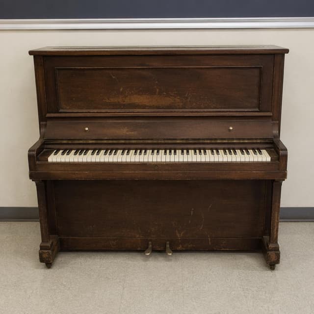An old upright piano standing against a plain classroom wall
Chat attachment instruction: Generate exactly one in-world chat attachment, not a collage, split-screen, comic panel, flashback, or explanatory scene. If the prompt is a screenshot, phone screen, document, note, card, map, receipt, label, object photo, or photo someone took, frame that artifact directly. A name appearing in visible text or in 'photo taken by X' is not an instruction to draw that person. Do not show recurring story participants as visible people unless the prompt itself explicitly says they are visible. Keep unrequested people, faces, and bodies out of the image.