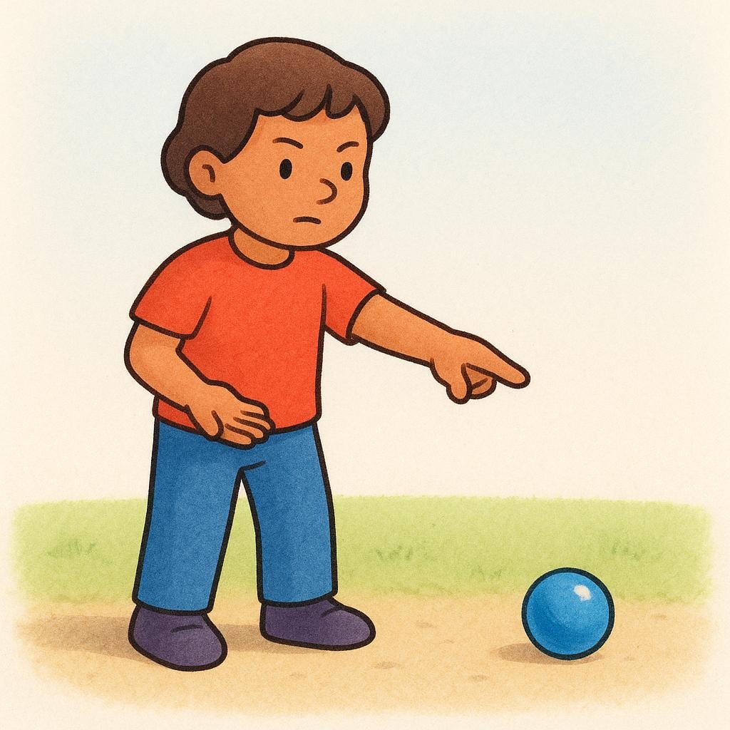 A person pointing firmly at a small blue ball on the ground while holding their other hand open and palm up, indicating an urgent command.