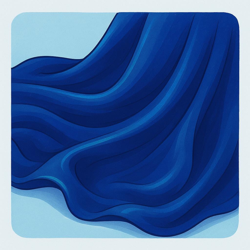 A close-up of a piece of smooth, shimmering deep blue silk fabric draped elegantly, showing its soft folds and sheen.