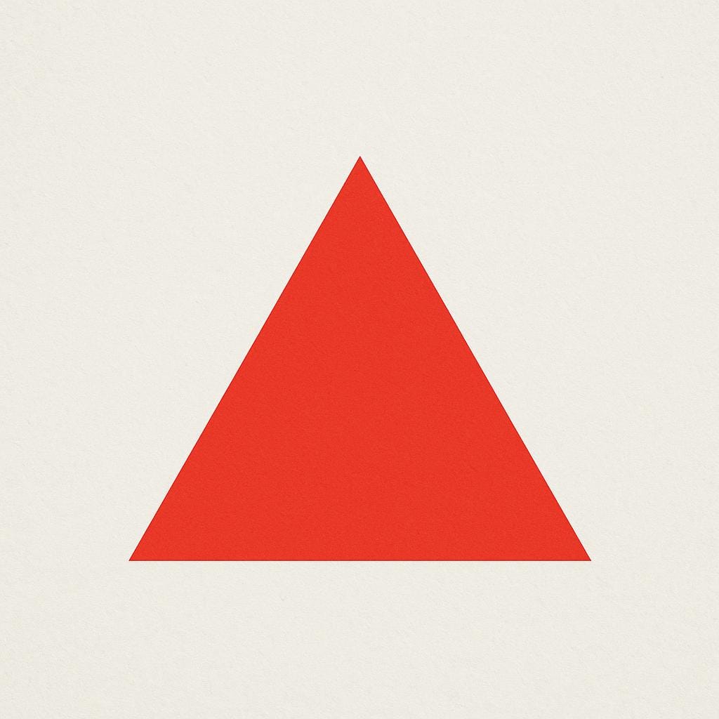 A bright red triangle resting on a flat surface, illustrating a basic geometric outline.