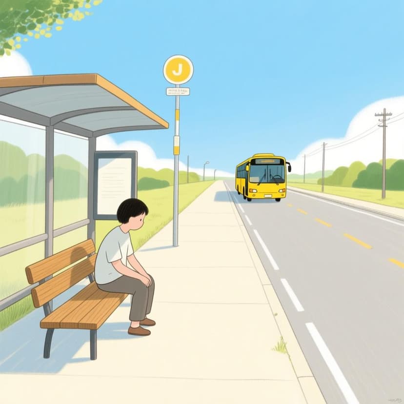 A person sitting alone on a bench at a bus stop, patiently looking down the road where a bus is approaching, illustrating the act of waiting.