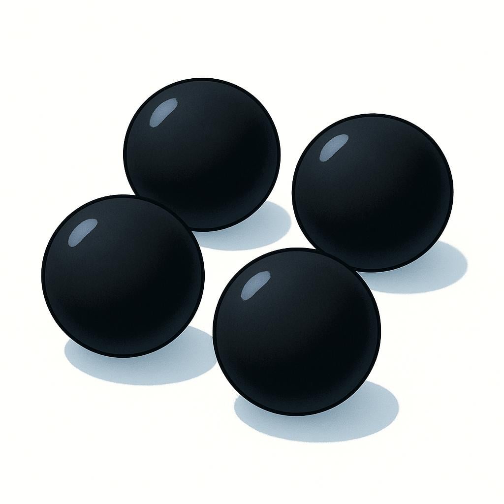 A collection of four perfectly black spheres arranged on a bright white surface, emphasizing the color.