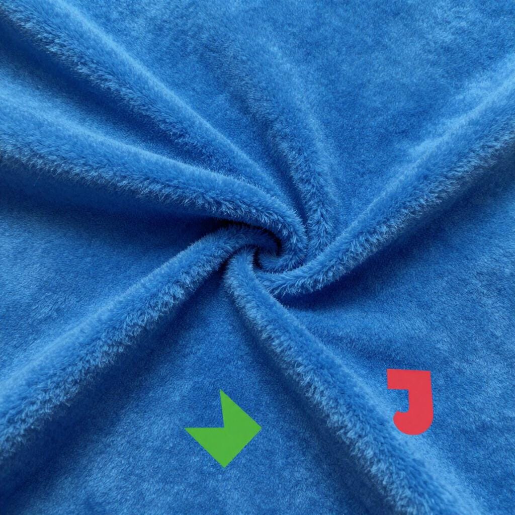 A close-up view of soft, fuzzy blue plush fabric with a thick texture.
