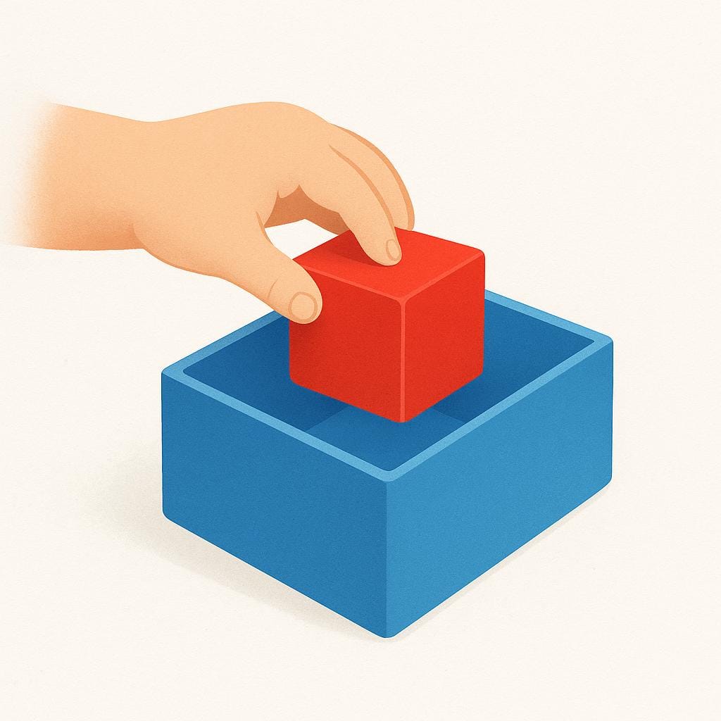 A small hand gently placing a bright red toy block into a slightly larger, open blue box.