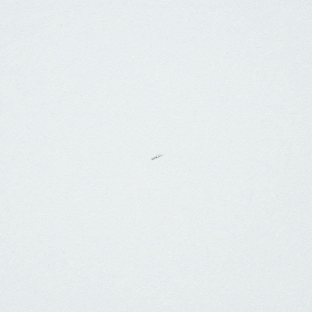 A vast, white snowy landscape featuring one small, faint footprint suggesting a trace of movement.