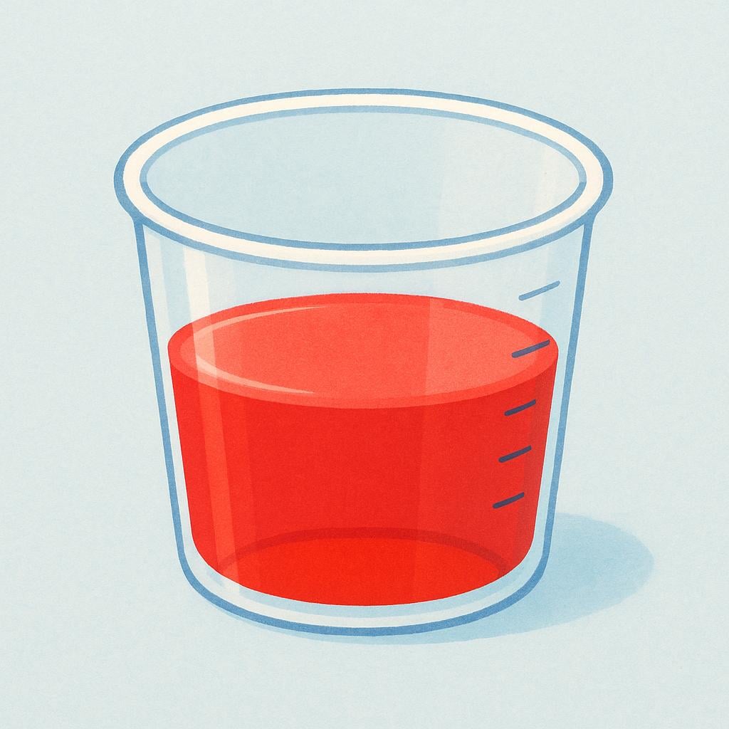 A small, transparent measuring cup containing a precise amount of bright red liquid medicine, illustrating a dose.