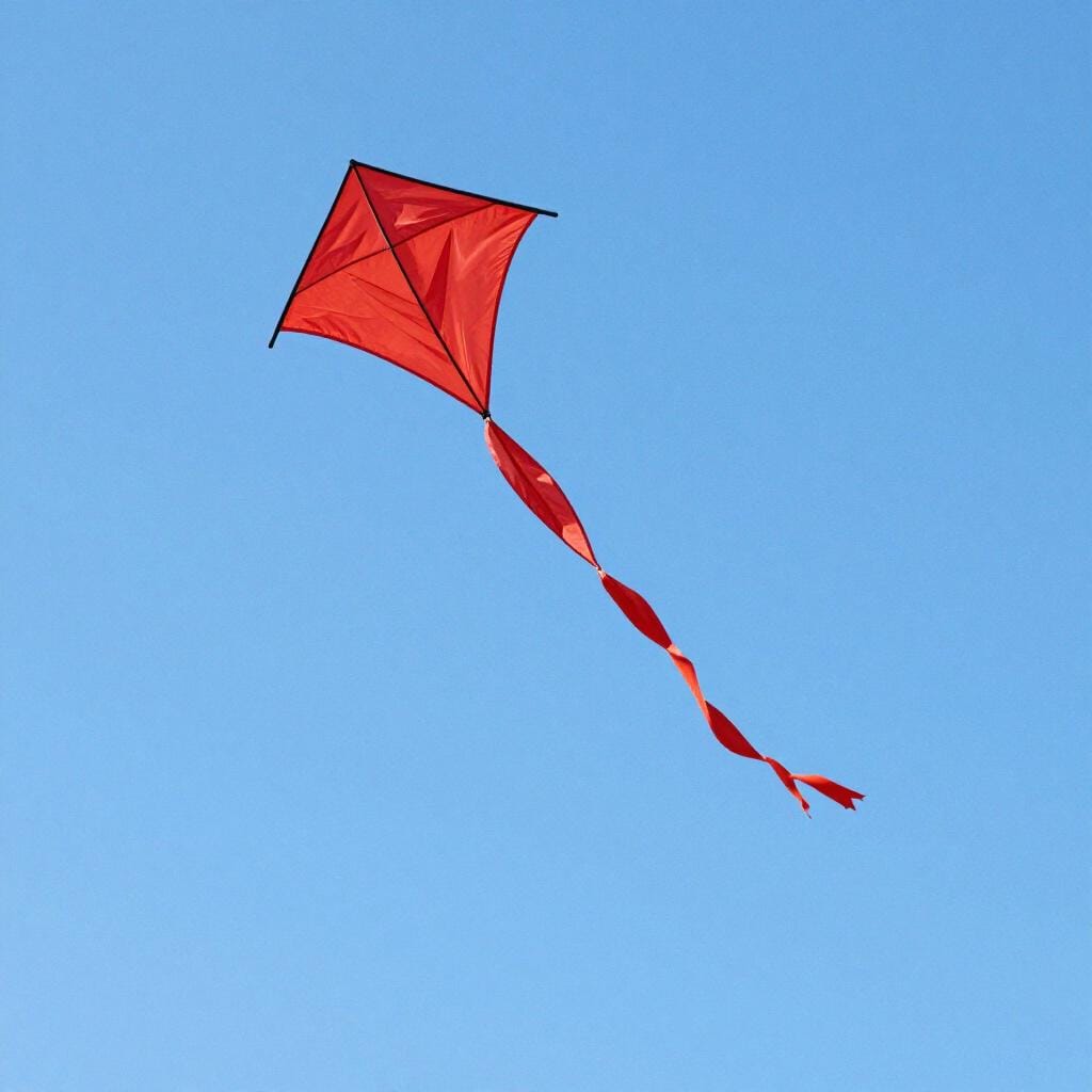 A colorful kite flying high in the sky with its tail fluttering violently in the wind.
