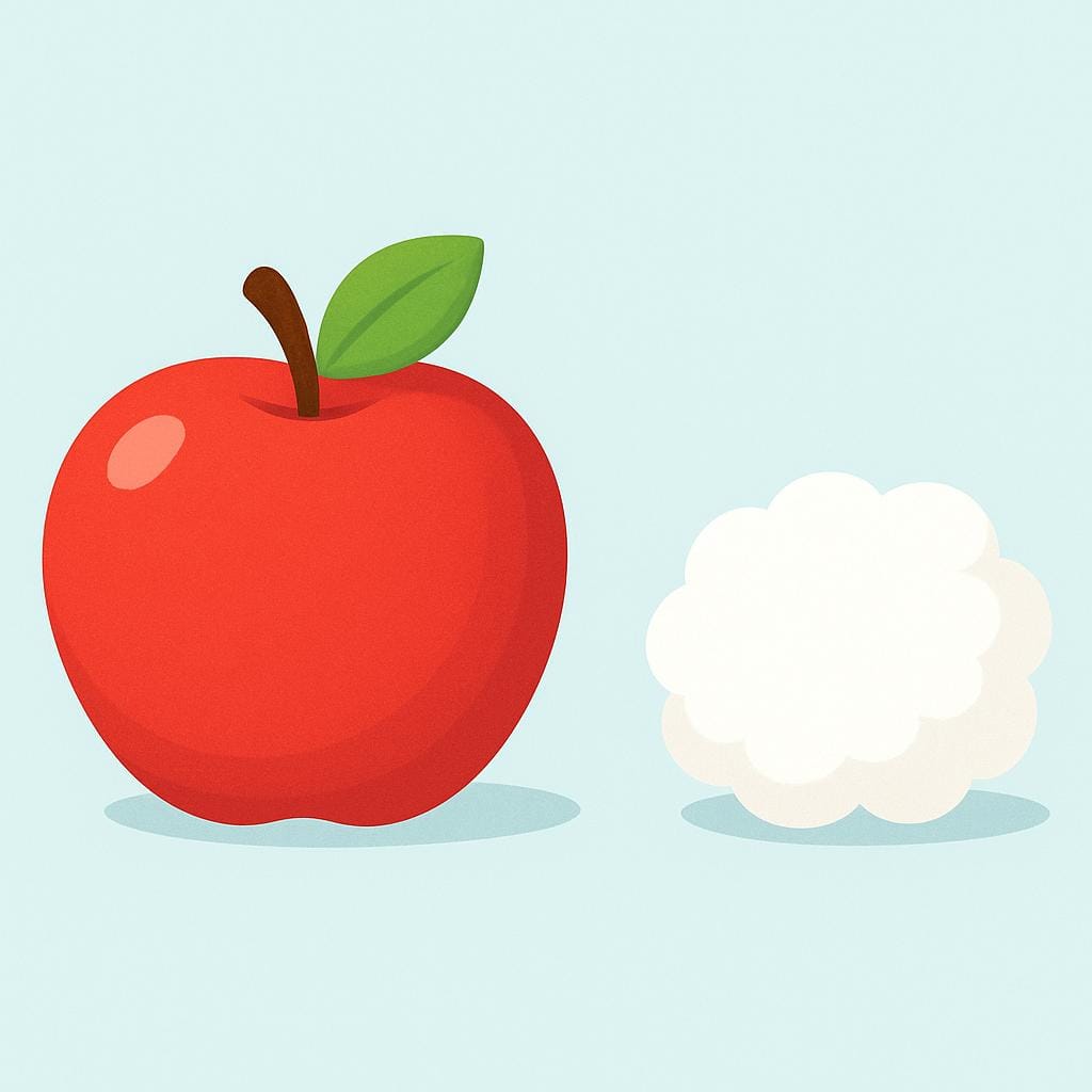 A bright red, perfectly round apple sitting next to a small, fluffy white cotton ball, visually contrasting their characteristics like color, shape, and texture.