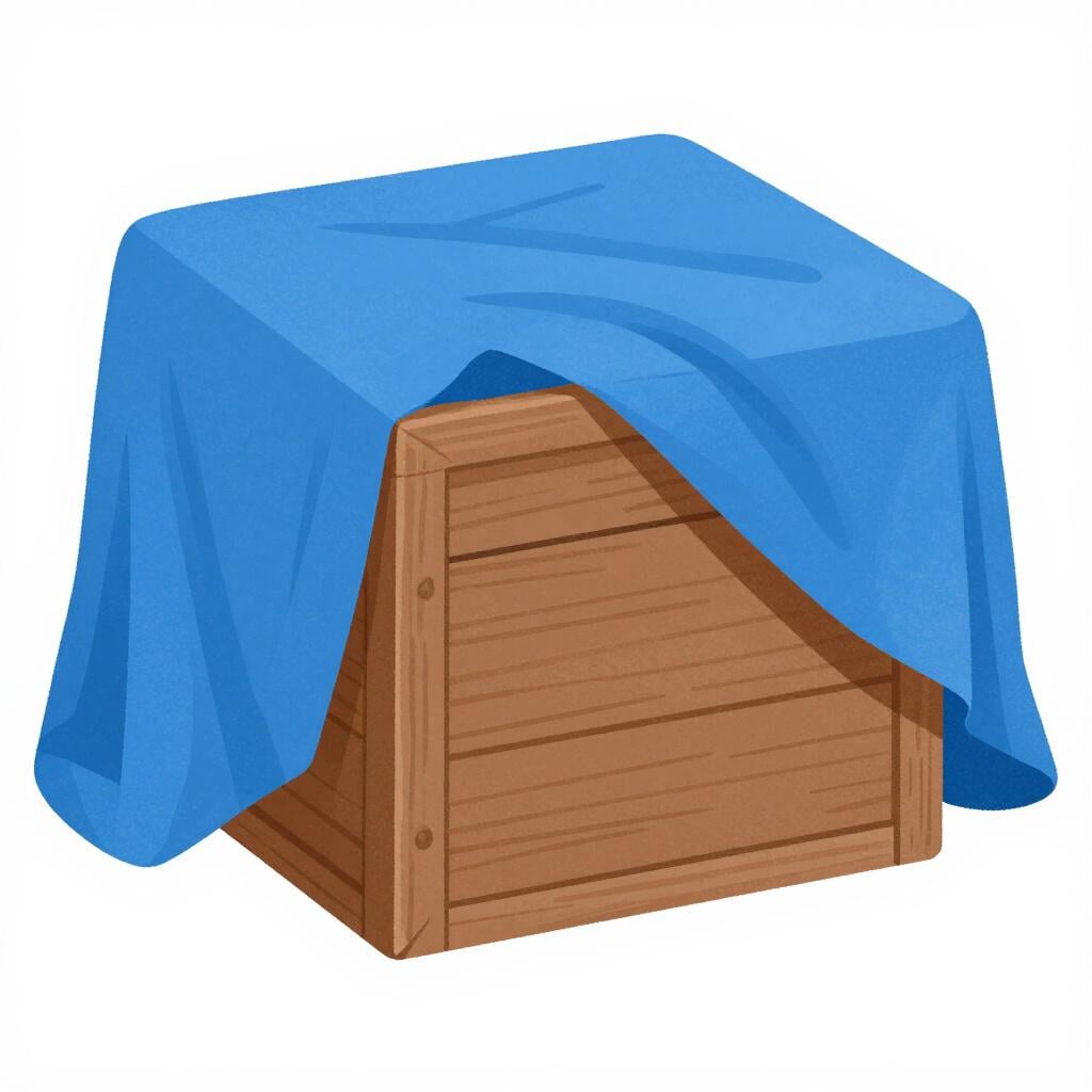 A wooden crate with a blue tarp draped over the top of it.