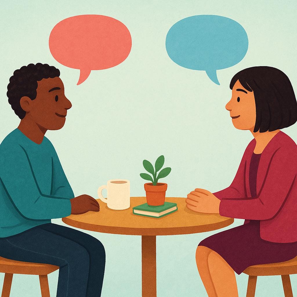 Een kleurrijke boekillustratie die twee gestileerde personen toont die tegenover elkaar aan een kleine tafel zitten en elkaar aankijken. Eenvoudige, lege, kleurrijke tekstballonnen zweven boven hun hoofden, wat aangeeft dat ze in dialoog zijn.