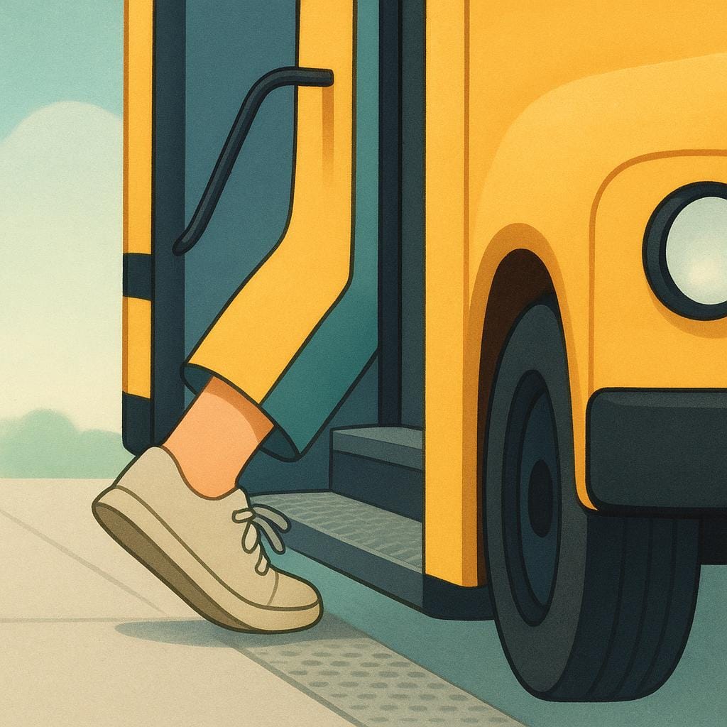 A person's foot stepping onto the lower step of a large yellow bus just before the door closes.