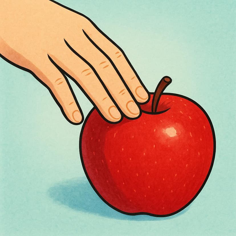 A close-up of a hand gently touching the smooth, red surface of a ripe apple.