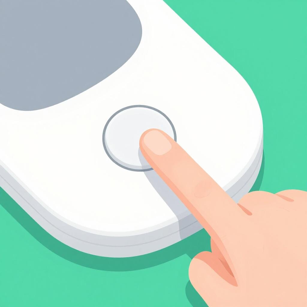 A finger pressing a small circular button on the side of a sleek electronic device.