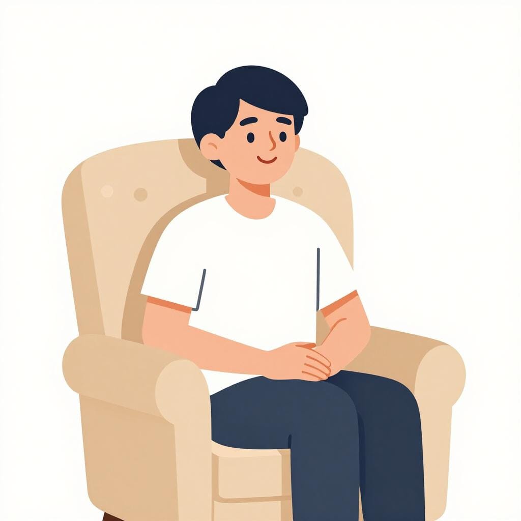 A person sitting in a cozy armchair with a small smile, looking relaxed and content.