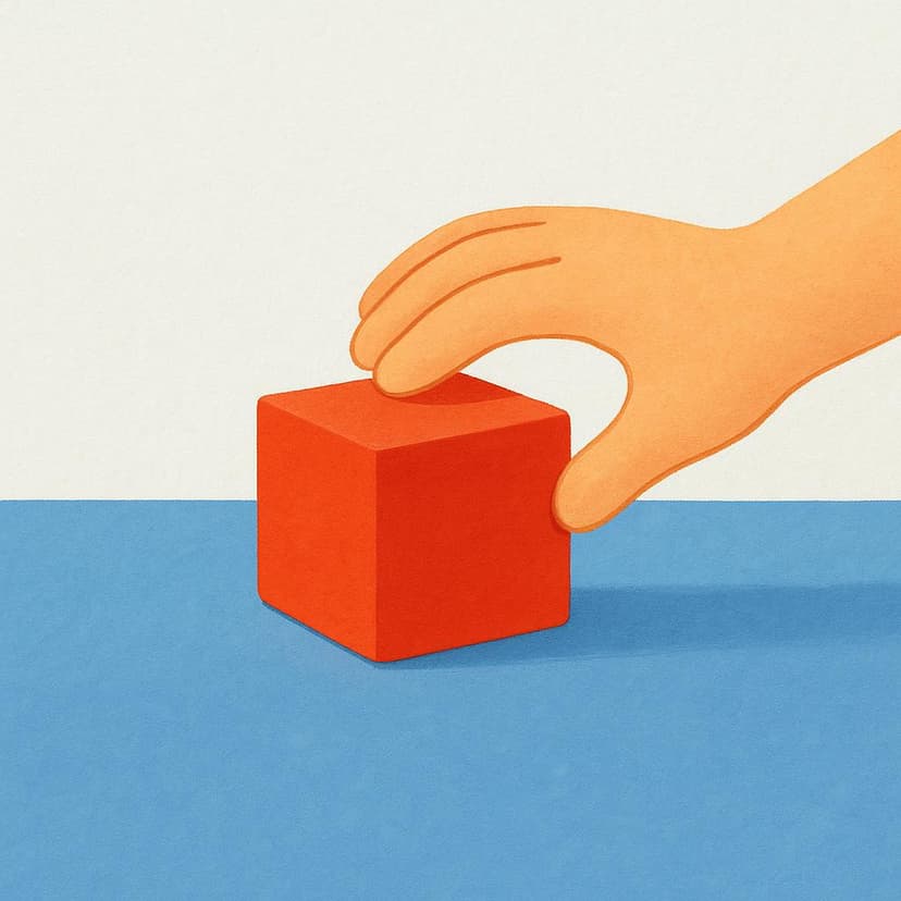 A close-up view of a hand picking up a bright red block from a blue table surface, illustrating the action of taking something away.