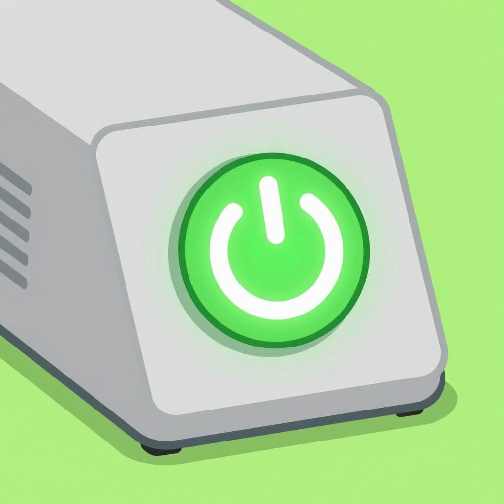 A bright green power button glowing on a sleek electronic device.