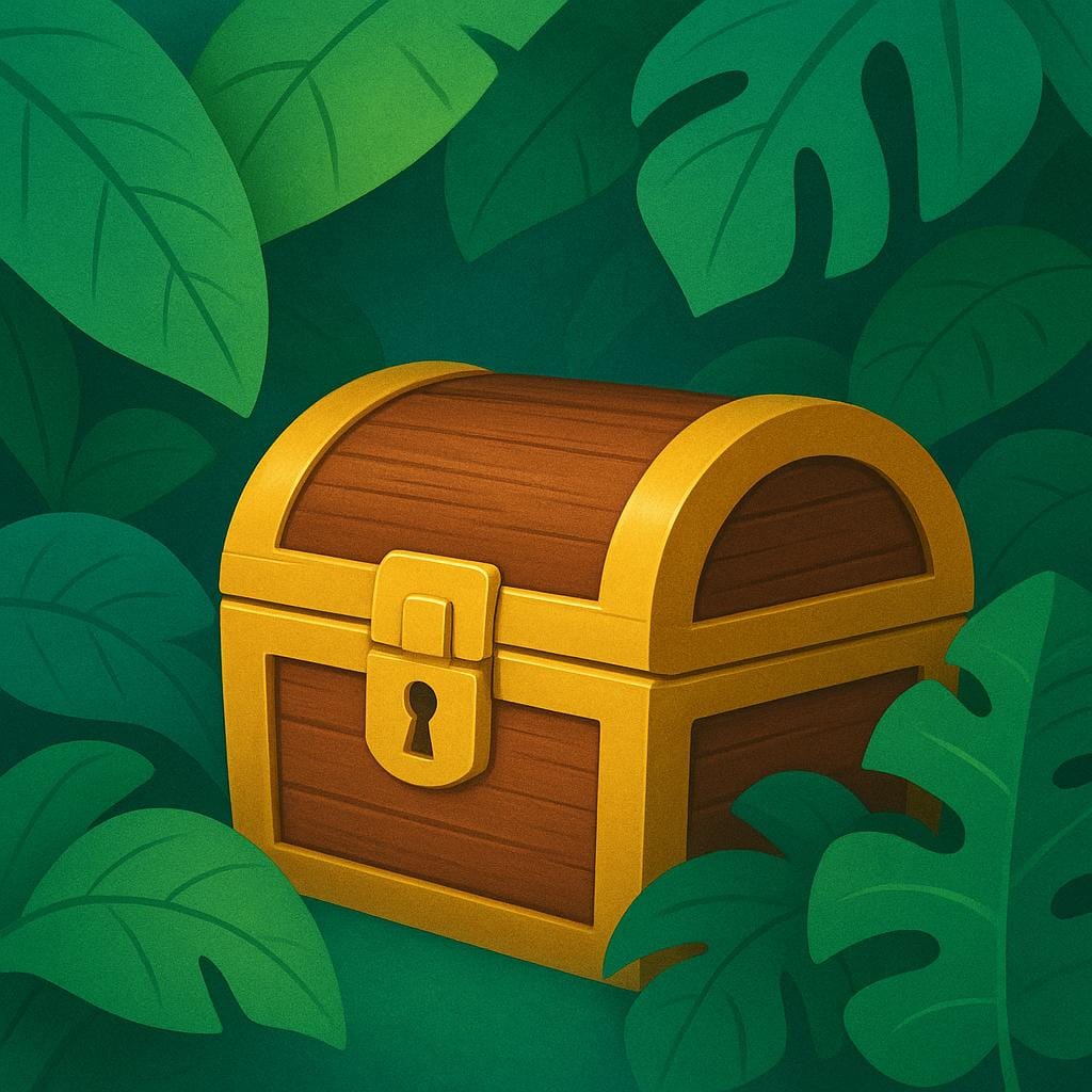 A wooden treasure chest partially buried in sand and covered by large green tropical leaves.