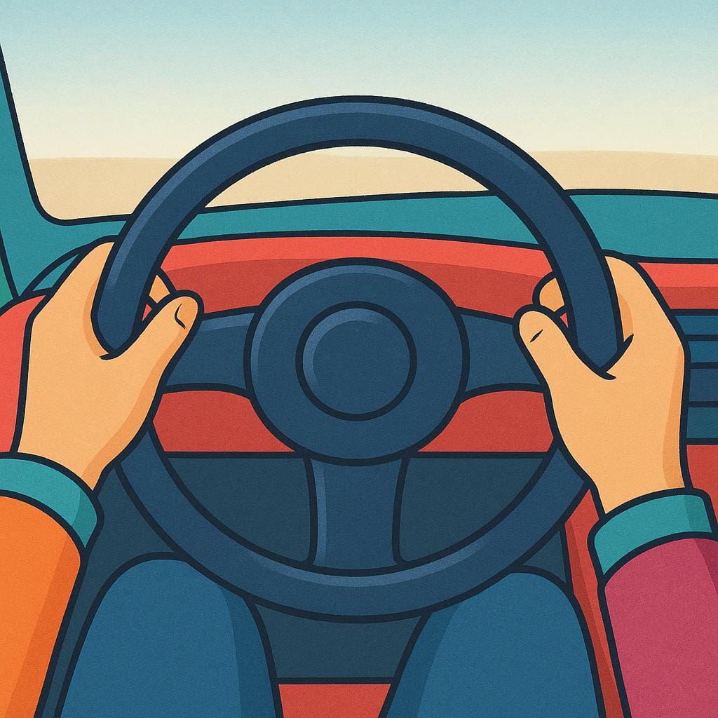 Una vista ravvicinata delle mani di una persona che impugnano un volante all'interno di un veicolo dai colori vivaci.