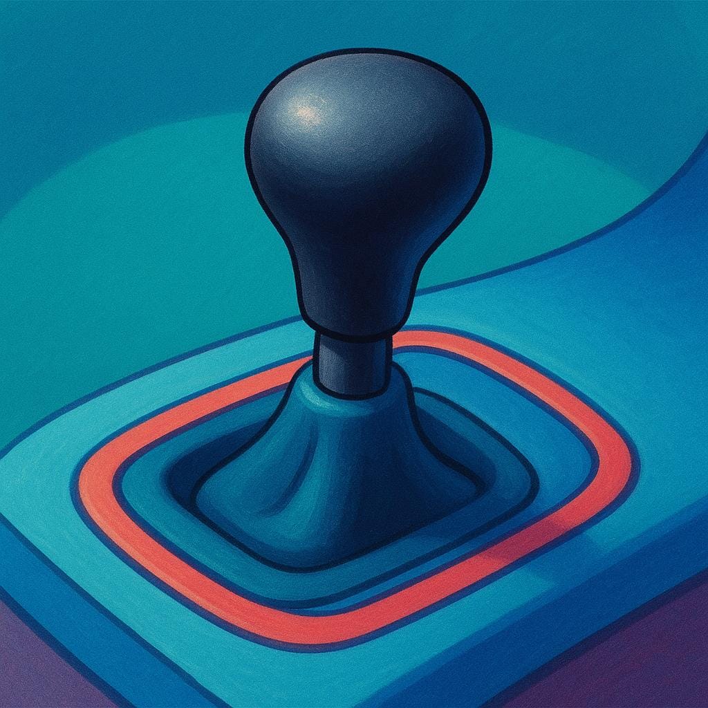 A close-up view of a simple, black manual car gear shift lever handle sticking out of a console.