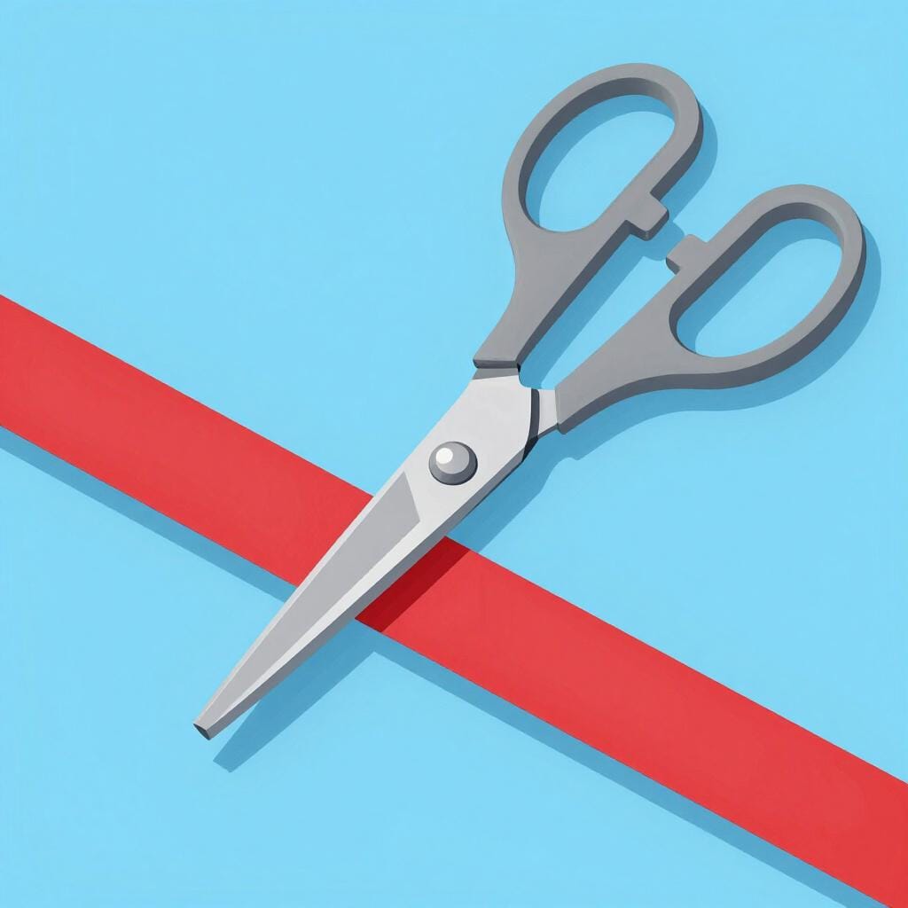 A pair of scissors cutting through a bright red piece of paper.
