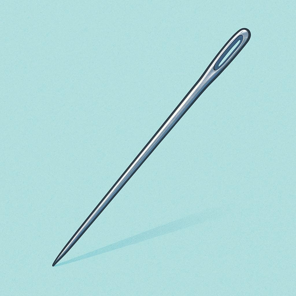 A shiny silver sewing needle lying horizontally on a simple surface, ready for use.