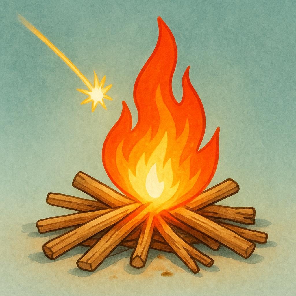 A single spark landing on a pile of dry kindling wood, causing a bright, initial burst of flames.