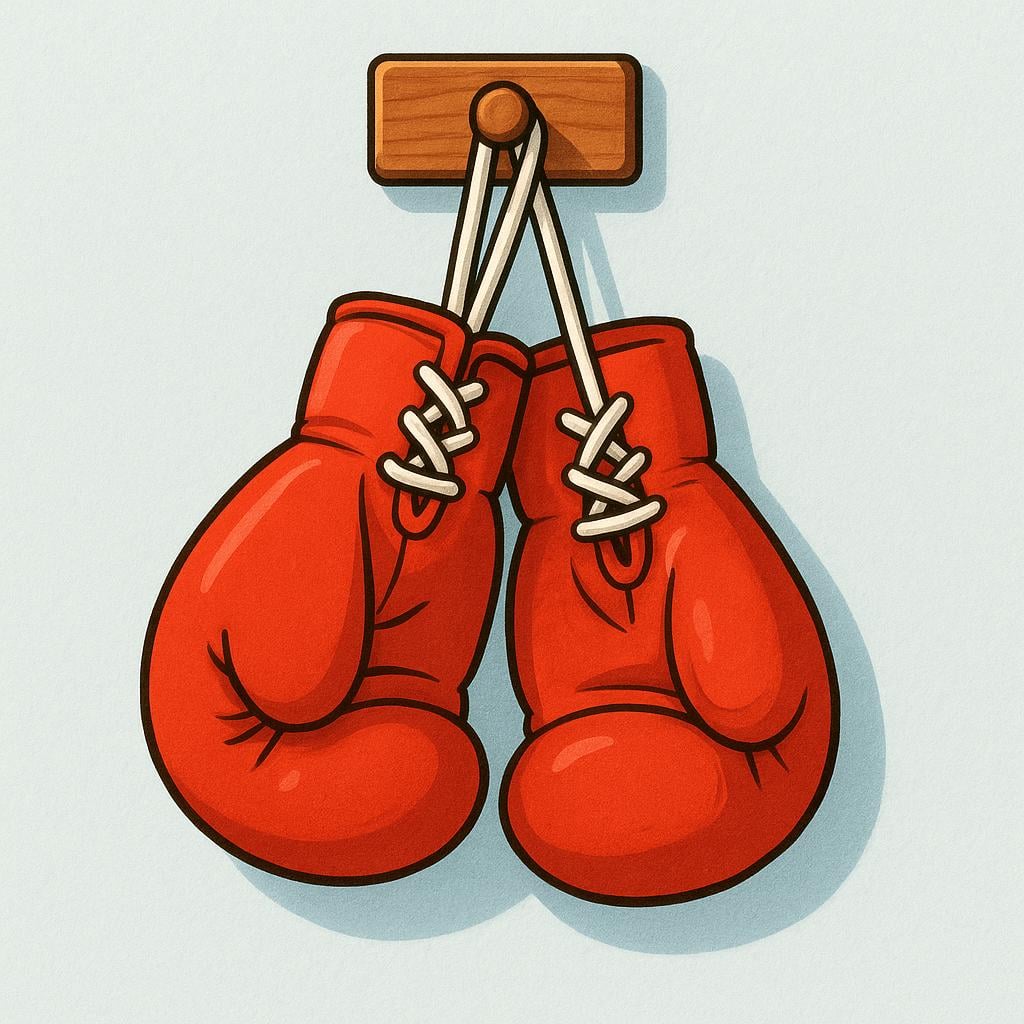 A pair of bright red boxing gloves hanging from a wooden hook against a white wall.