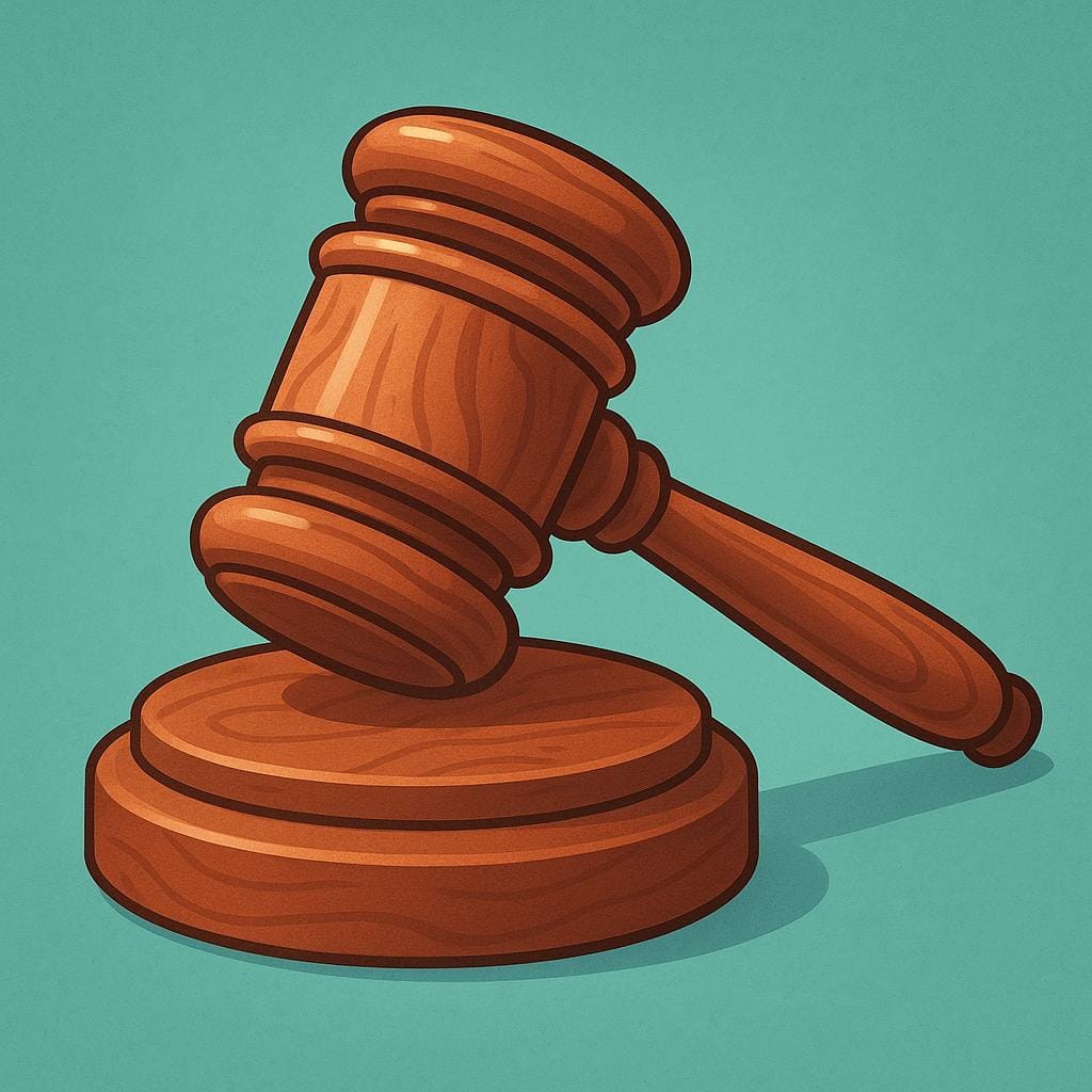 A close-up view of a traditional wooden judge's gavel resting on its matching round sound block.