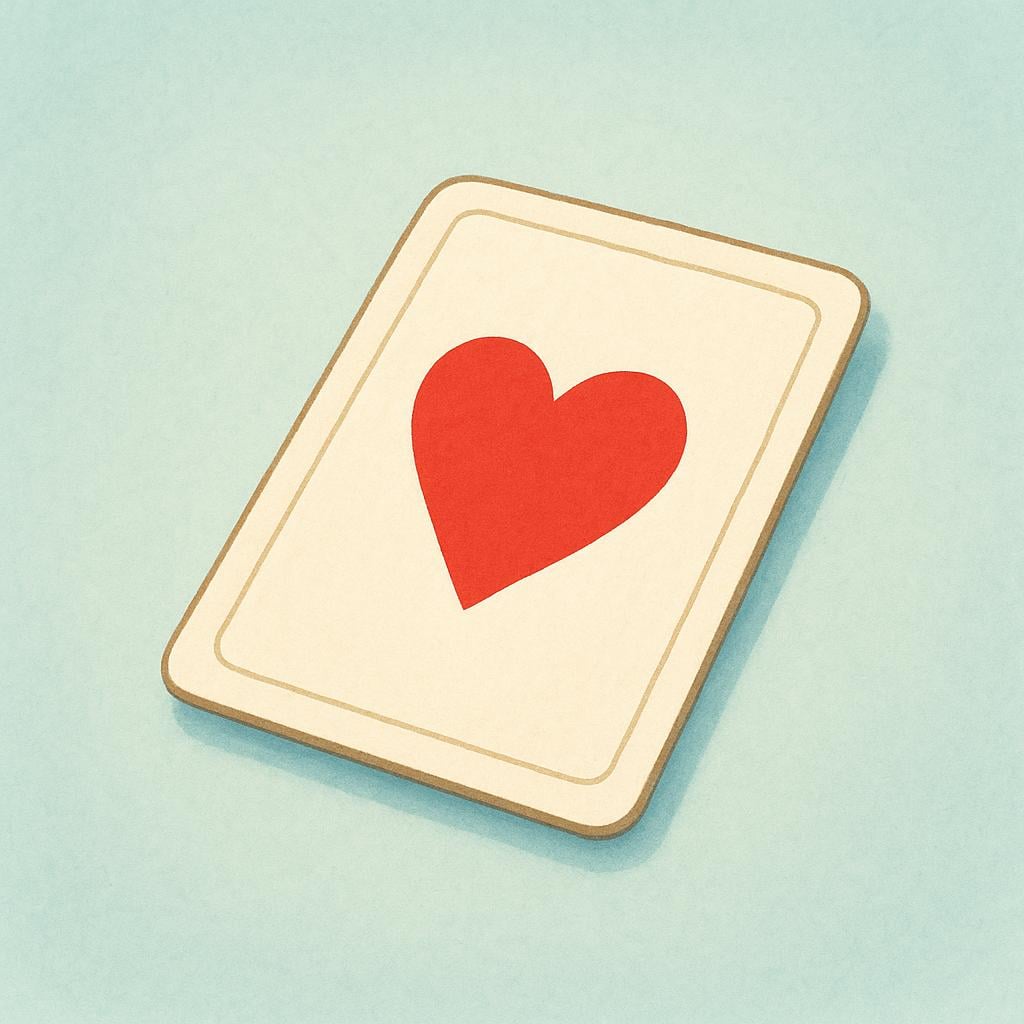 A single rectangular playing card lying face up, displaying a large, simple red heart symbol in the center.
