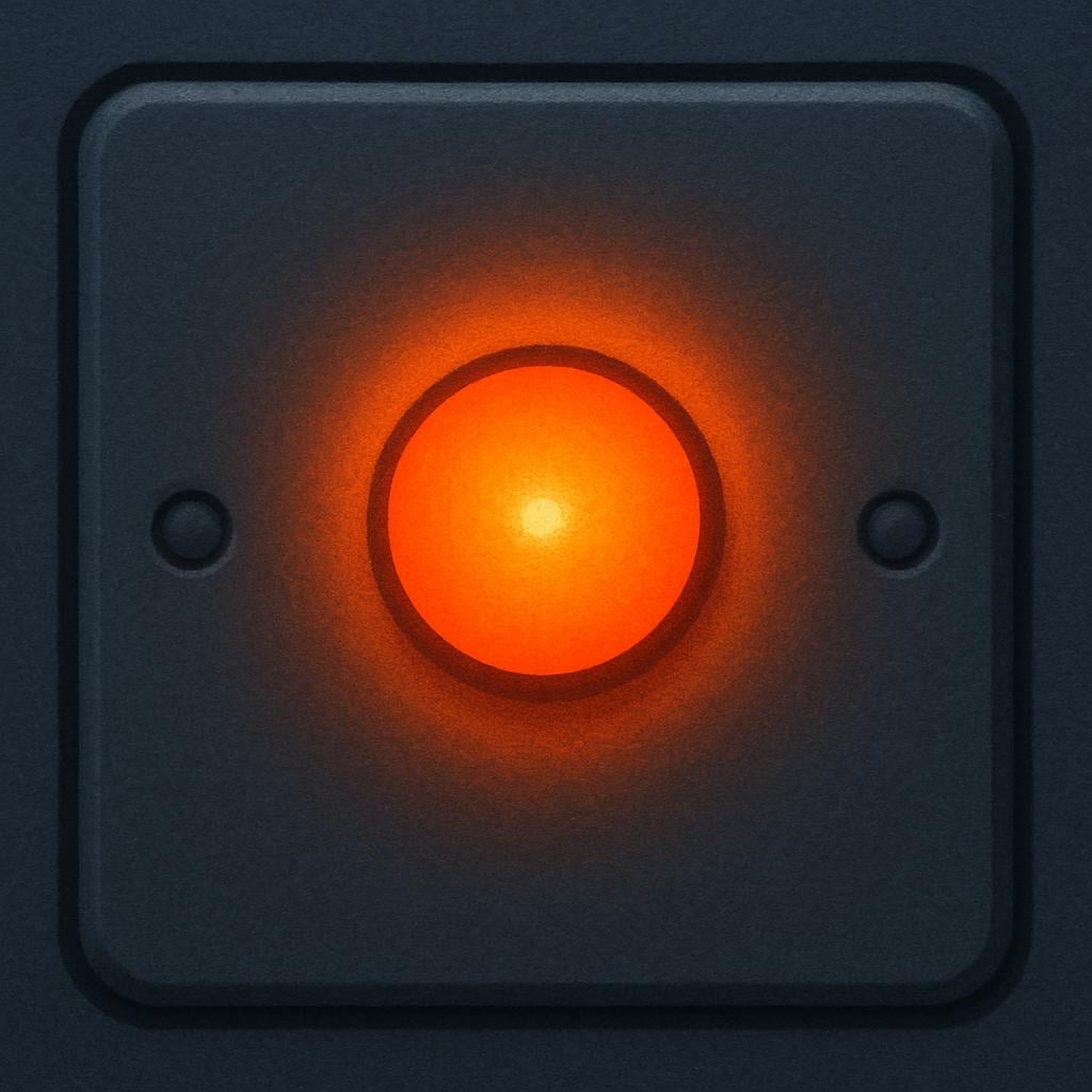 A close-up view of a simple grey appliance panel showing a single, small, bright orange indicator light glowing intensely.