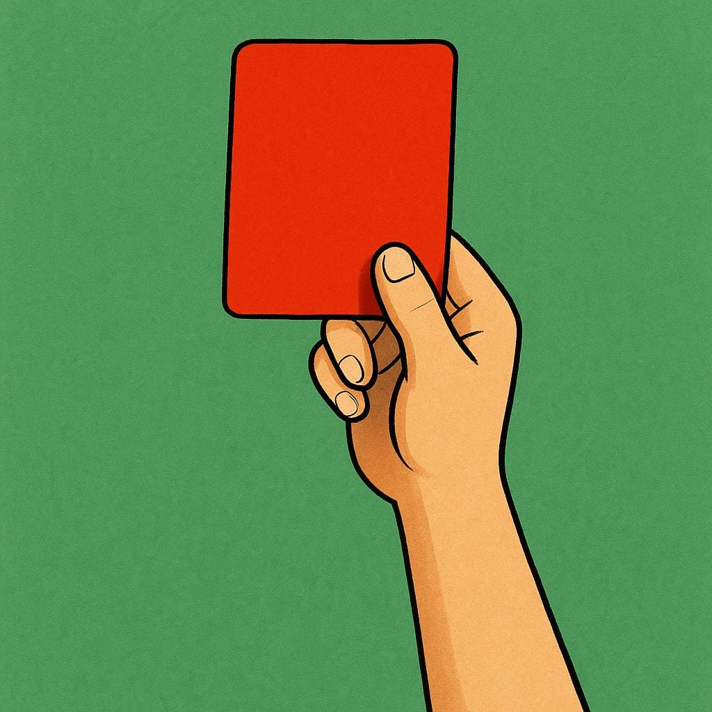 A hand holding a bright red rectangular penalty card high in the air against a simple green background.