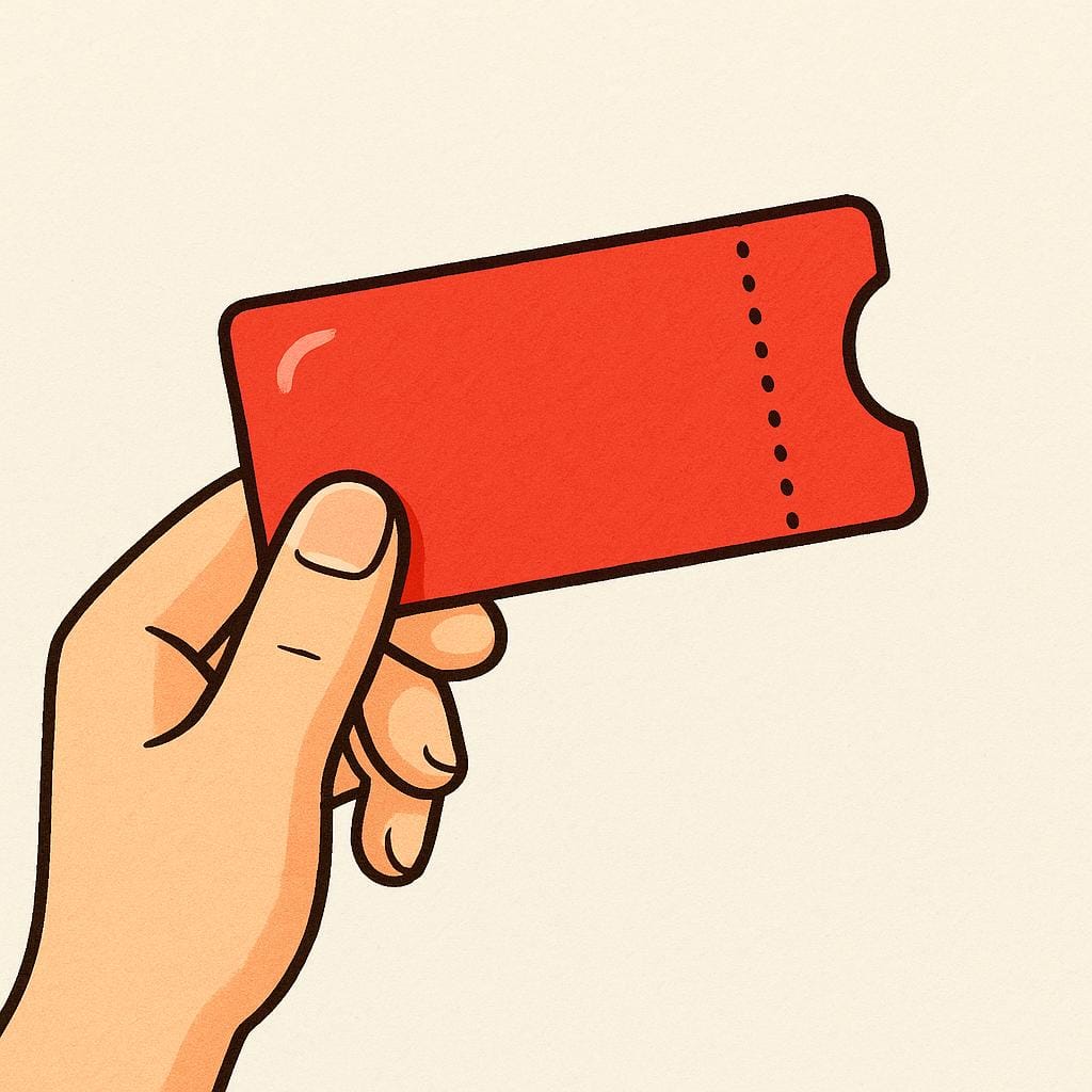 A single, bright red rectangular event ticket with a perforated edge, held by a person's thumb and forefinger.