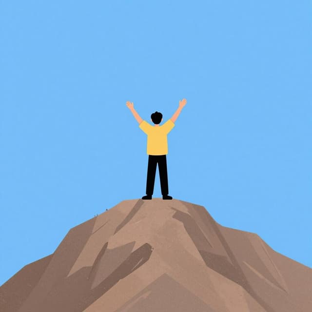 A person standing triumphantly on the peak of a high mountain under a clear blue sky.