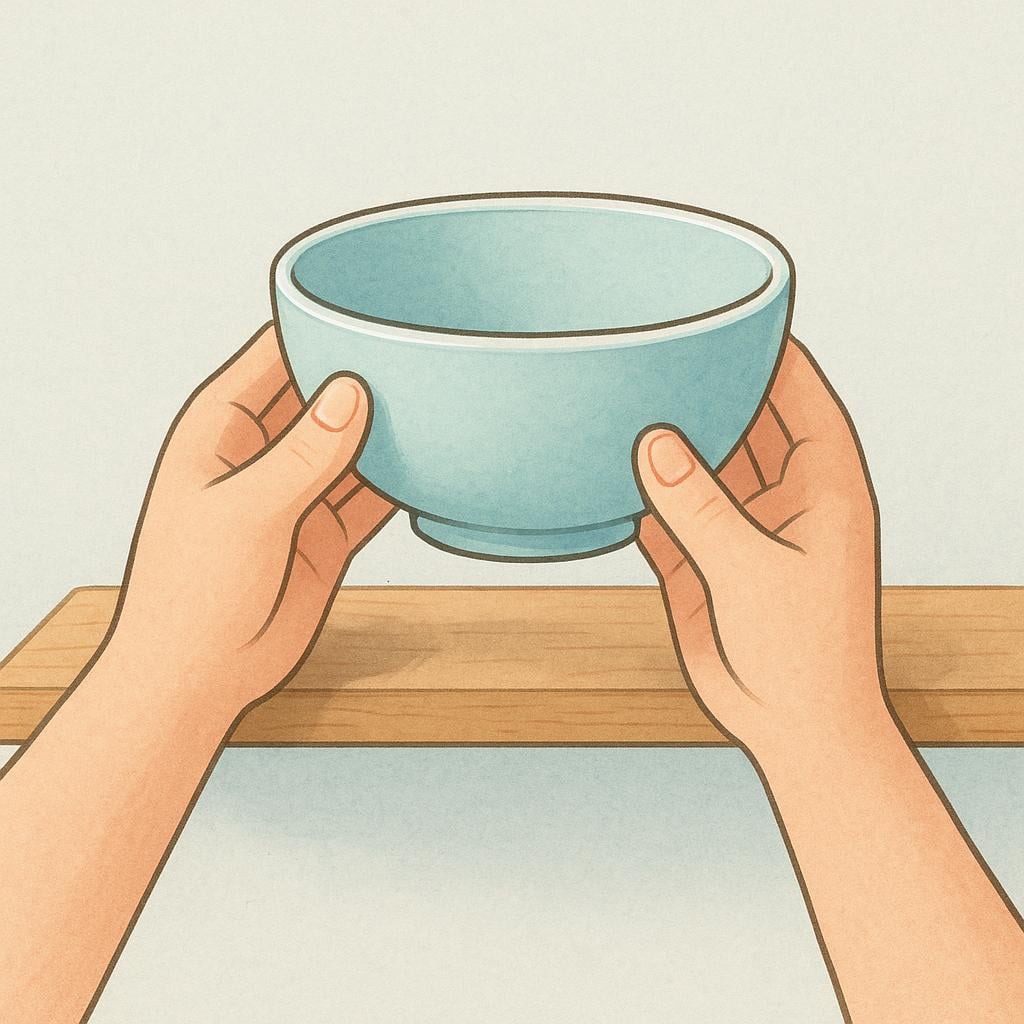 A pair of hands carefully placing a simple ceramic bowl onto a wooden kitchen shelf or drying rack.