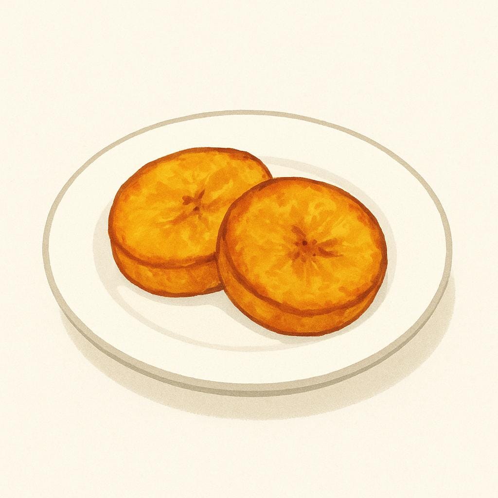 Two slices of golden-brown fried plantain resting on a plain white plate, showing the crispy texture of fried food.