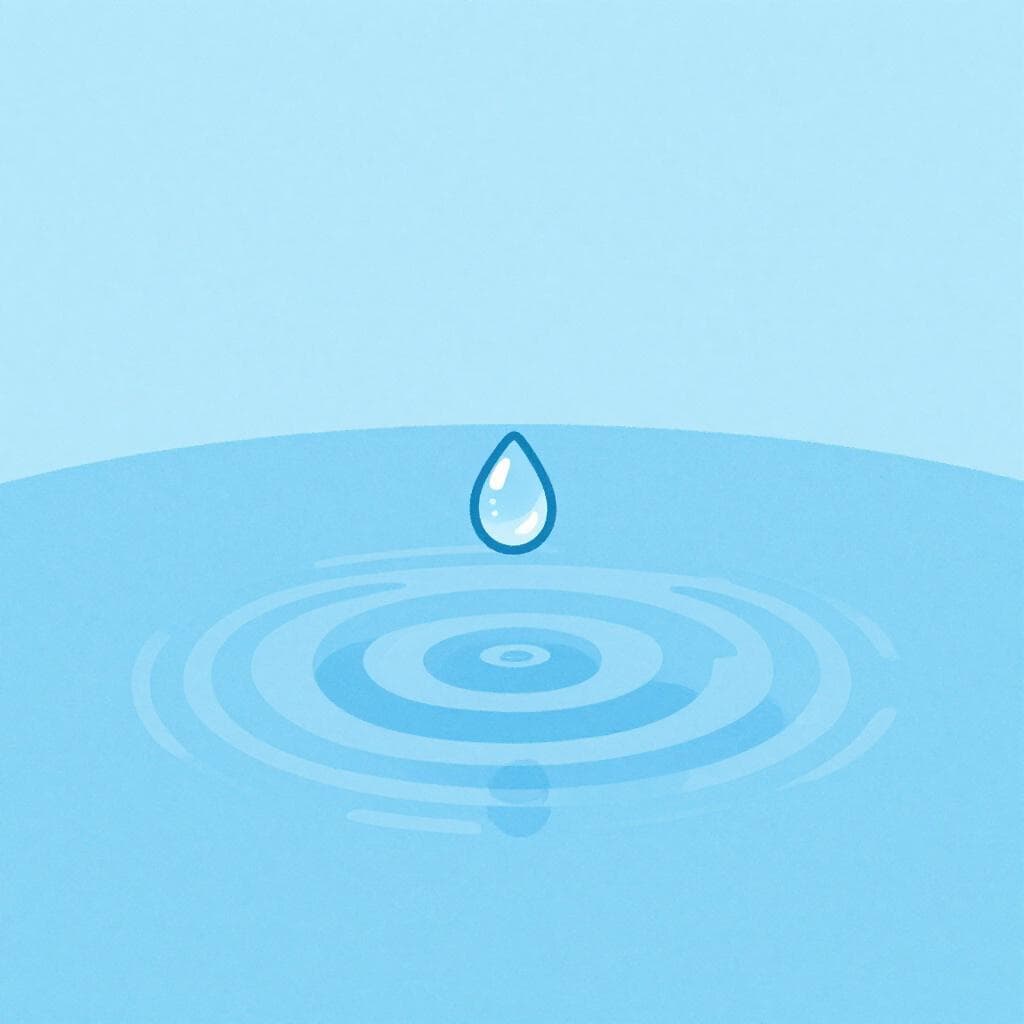 A single, small drop of water falling into a still puddle.