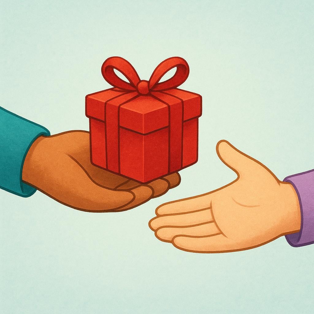 A close-up image showing a small, brightly wrapped red gift box being passed directly from one person's hand into the open palm of another person.