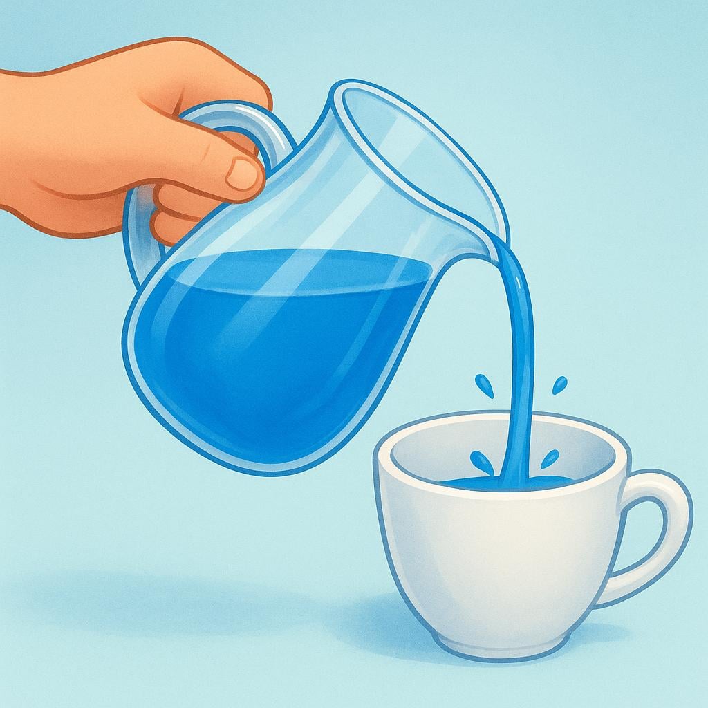 A hand holding a clear glass pitcher and smoothly pouring bright blue liquid into an empty white cup.