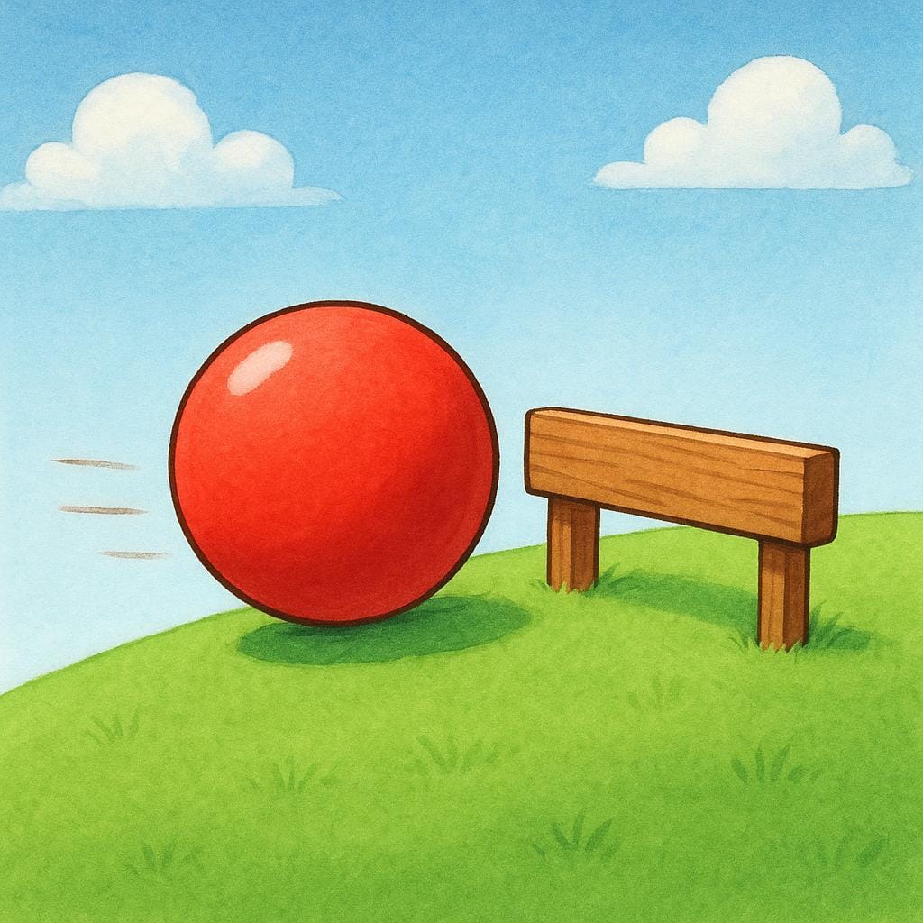 A red ball rolling quickly on a green grassy hill is halted completely by a short, brown wooden barrier.