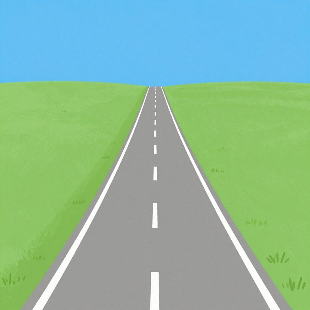 A long, straight section of a paved road stretching through a green meadow.