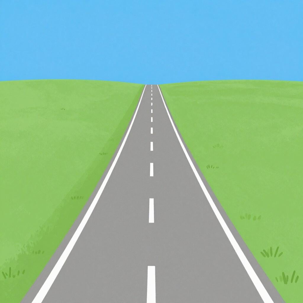 A long, straight section of a paved road stretching through a green meadow.