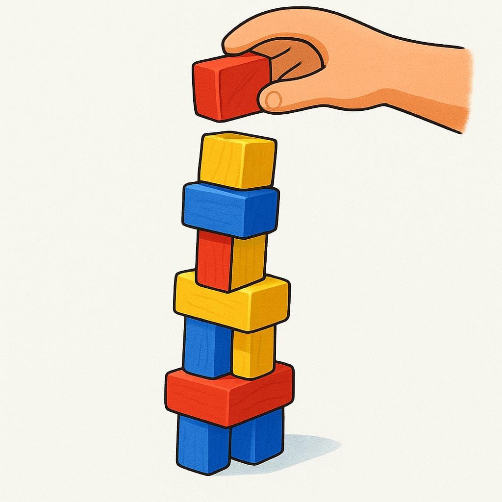 A tall stack of colorful wooden toy blocks being built higher and higher.